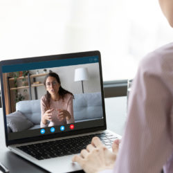 Businesswoman having distant negotiations using video conference application on pc